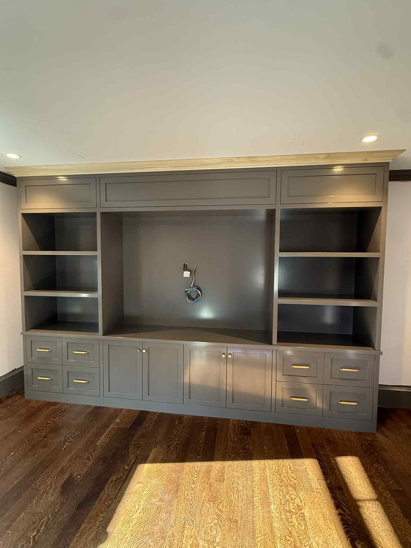 Custom built-in entertainment center with open shelving and drawers