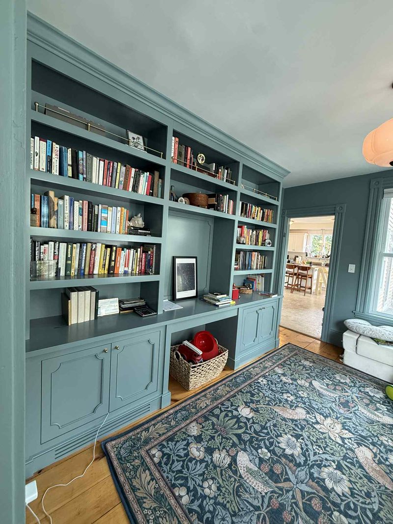 Custom built-in library bookcases with cabinet base in blue