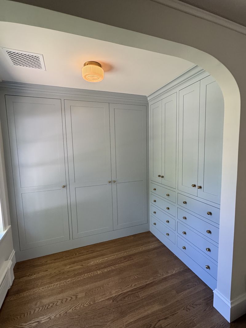 Custom built-in wardrobe and closet cabinetry with drawer bank