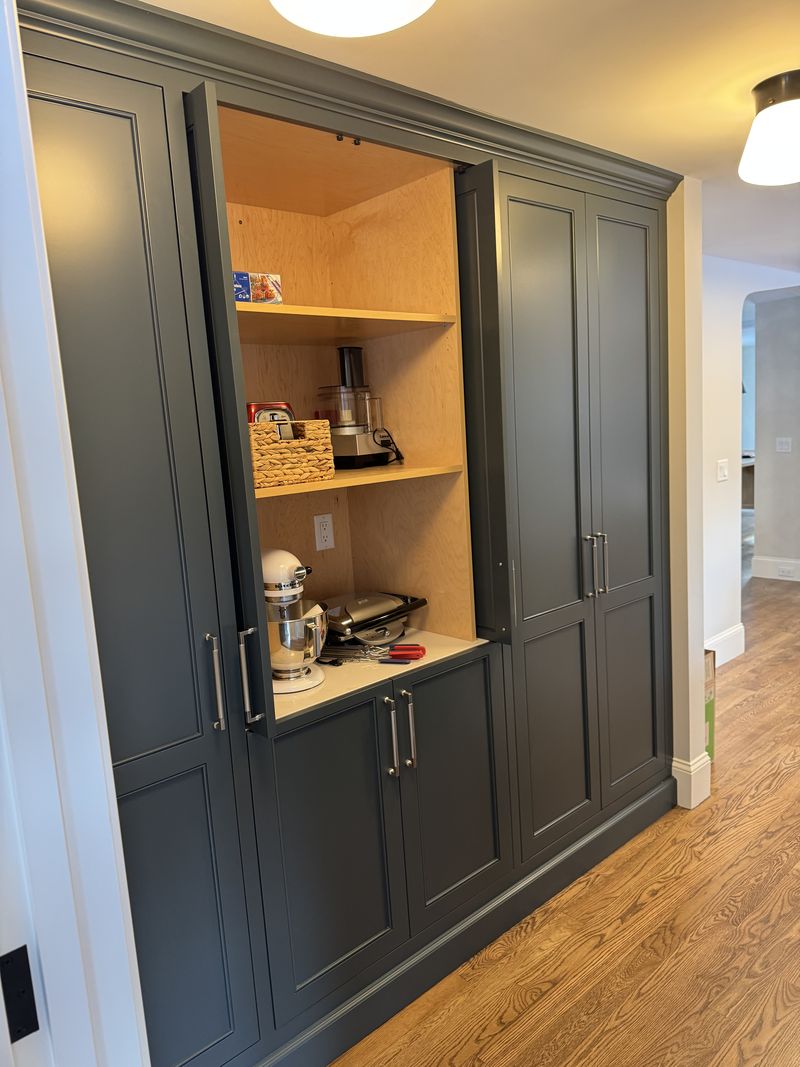 Custom charcoal pantry cabinets with appliance garage and maple interior