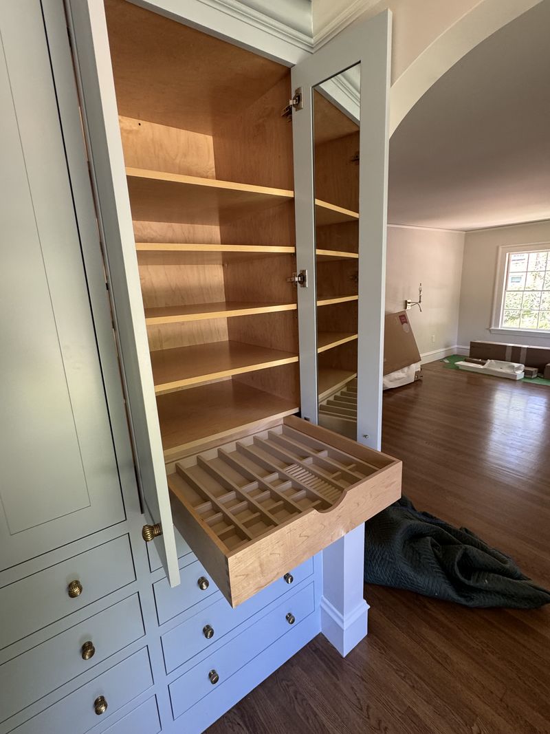 Custom closet interior with adjustable shelving and fitted drawer insert