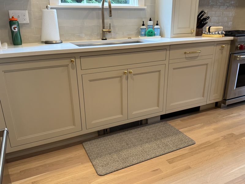Custom kitchen cabinets with brass hardware and quartz countertop