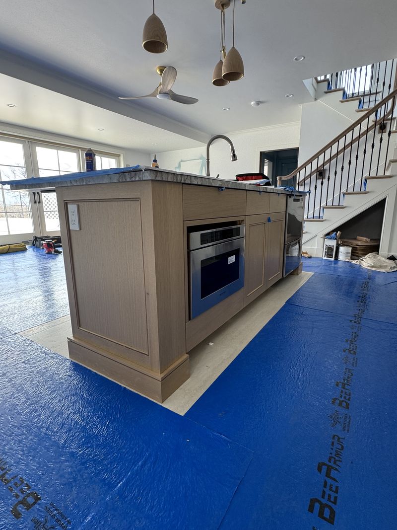 Custom kitchen island with integrated appliance during installation