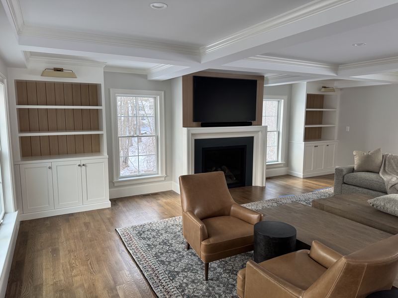 Custom living room built-ins and shelving flanking a fireplace