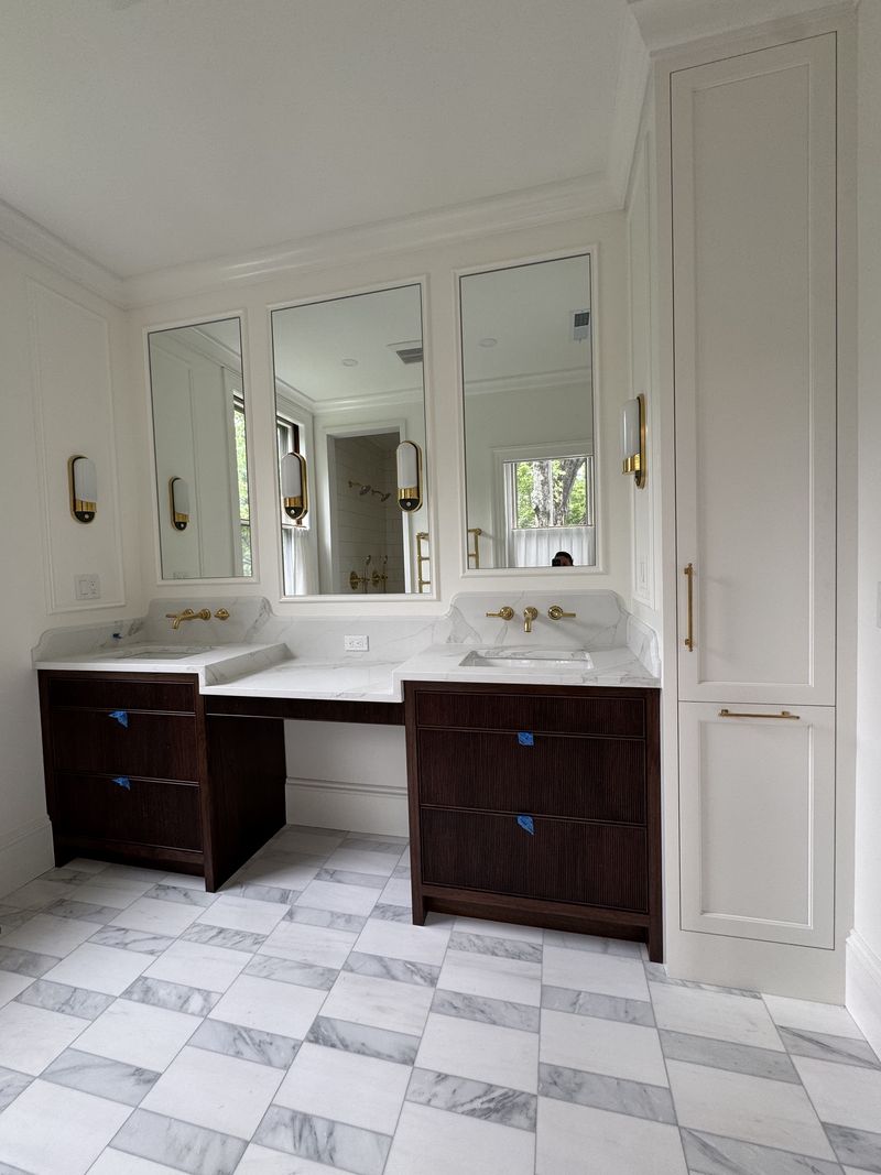 Custom walnut double bathroom vanity with makeup station and marble top